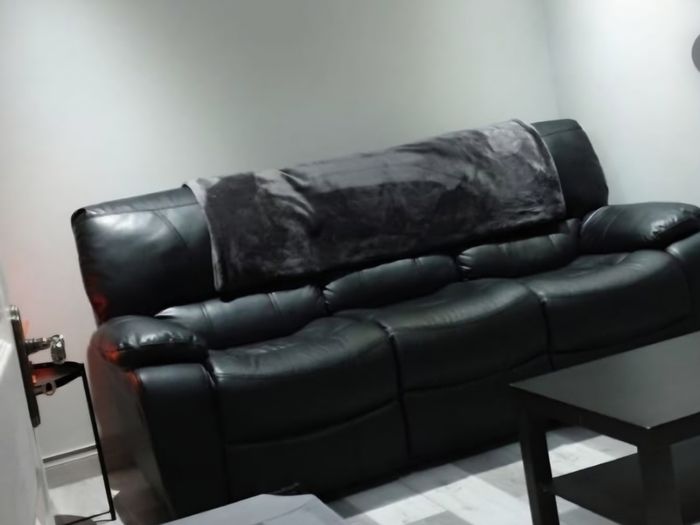 Black leather recliner sofa
