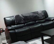 Black leather recliner sofa