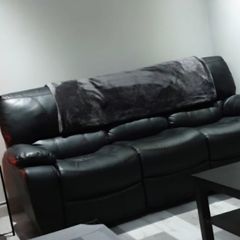 Black leather recliner sofa