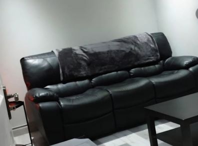 Black leather recliner sofa