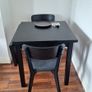 Black drop-leaf dining table with two chairs Image 2