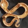 A striking snake-shaped brooch. Image 4