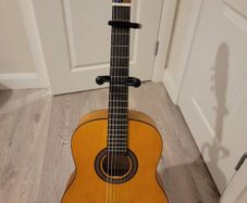 acoustic guitar with stand and capo
