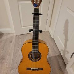 acoustic guitar with stand and capo