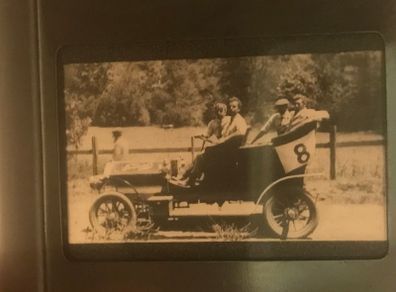 Antique glass lantern slide - photo of 4 young men sitting on antique car
