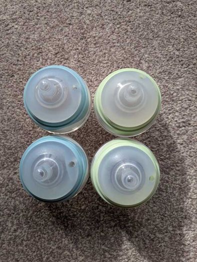4 small glass baby bottles