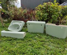 Avocado green sink and pedestal, 2 cisterns ,1 with no lid.