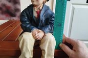 Resin sculpture of a seated boy