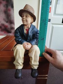 Resin sculpture of a seated boy