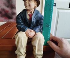 Resin sculpture of a seated boy