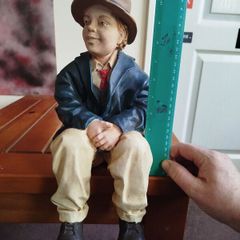 Resin sculpture of a seated boy