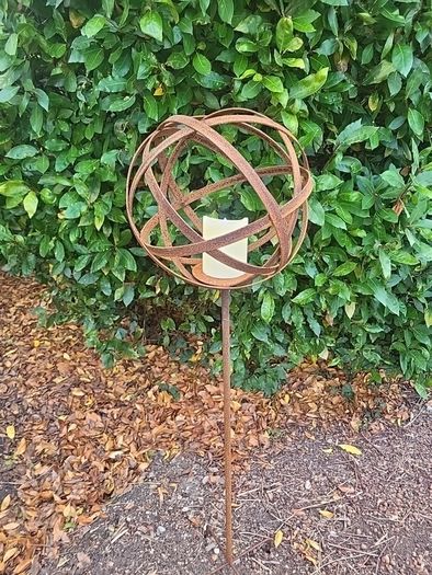 Corten steel garden sphere on a stem