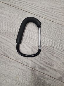 Large D-shape carabiner-style stroller hook with a foam grip also known as a buggy clip, mummy clip, or pram hook