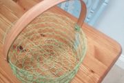 New wire woven basket with wooden handle