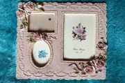 vintage-style pink resin multiple aperture photo frame with rose detailing.
