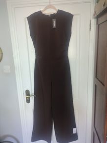 Boohoo jumpsuit Dark chocolate brown jumpsuit with gathered waist. Slight stretch in material.  Says sz 12 but small fitting.