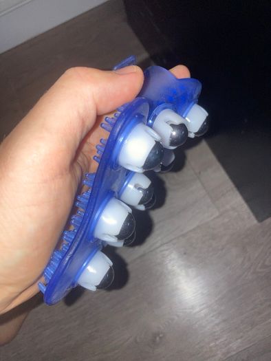 Palm-shaped manual massage glove with roller balls