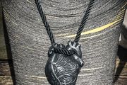 Anatomical heart made from black polymer clay with silver details on black rope