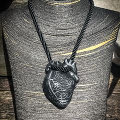 Anatomical heart made from black polymer clay with silver details on black rope