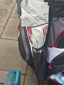 2 golf bags and various  club also jackets balls and tees shoes  and a trolly