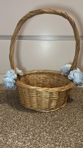 Wicker basket with artificial blue flowers.