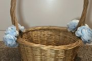 Wicker basket with artificial blue flowers.