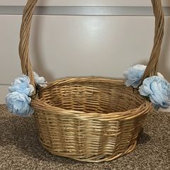Wicker basket with artificial blue flowers.
