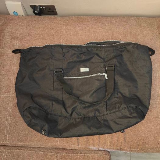 Large black expandable travel bag with shoulder strap