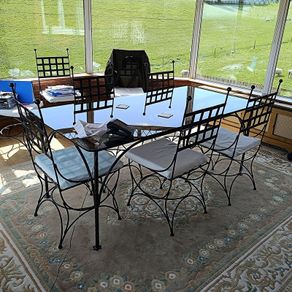 A Luxury Wrought Iron and Smoked Glass Dining Set With 8 Chairs