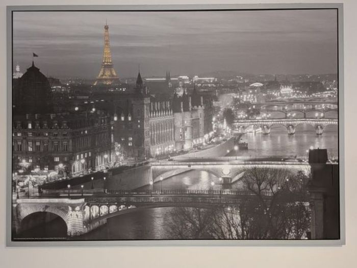 Two framed city pictures of Paris and Amsterdam