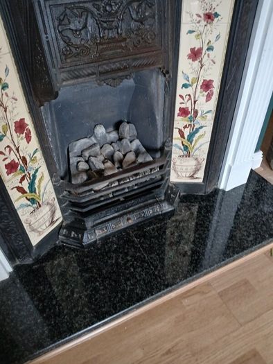 Fireplace in cast iron with wooden surround (painted white) and black marble hearth.   Perfect condition