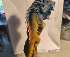 handmade iguana on natural wood log