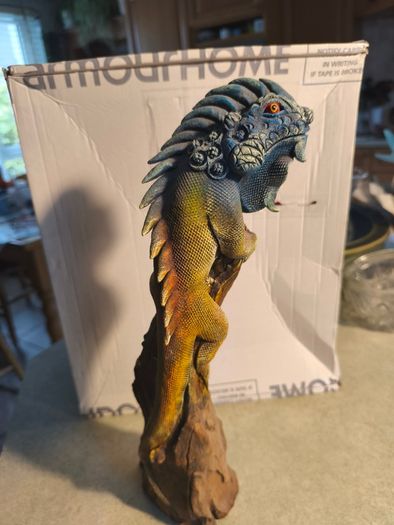 handmade iguana on natural wood log