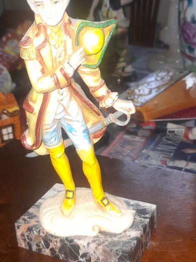 A Pair of Italian Depose Figurines The figurines depicts a 18th century Rococo style attire