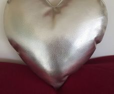 Heart shaped cushion. Gold colour.