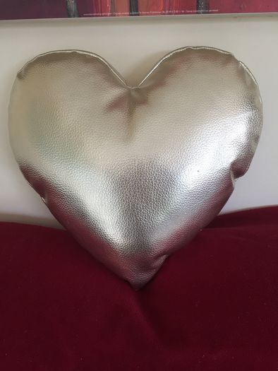Heart shaped cushion. Gold colour.