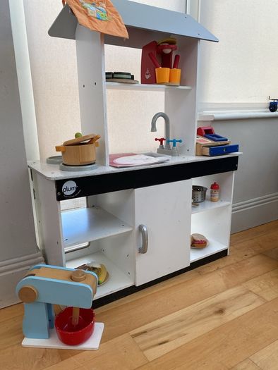 kids play kitchen by Plum with wooden food accessories