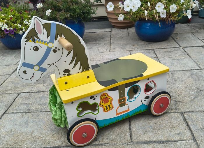 Wooden horse-themed ride-on toy in good used condition