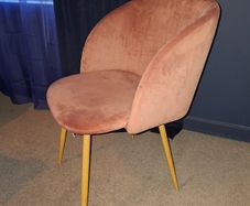 Plush pink velvet accent chair.