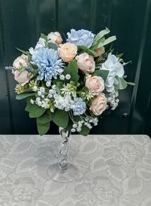 Artificial flower arrangement in glass vase