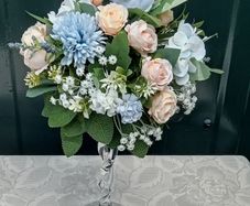 Artificial flower arrangement in glass vase