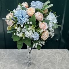Artificial flower arrangement in glass vase