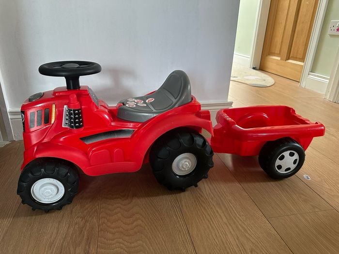 Red ride on tractor with trailer