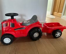 Red ride on tractor with trailer