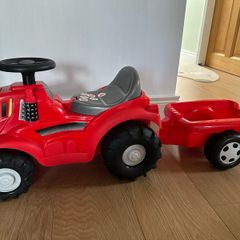 Red ride on tractor with trailer