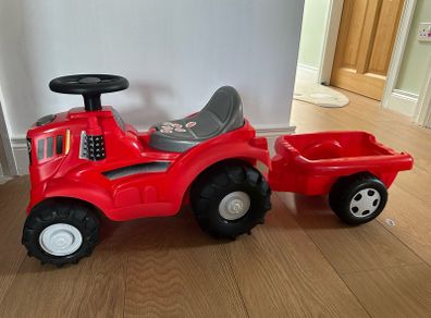 Red ride on tractor with trailer