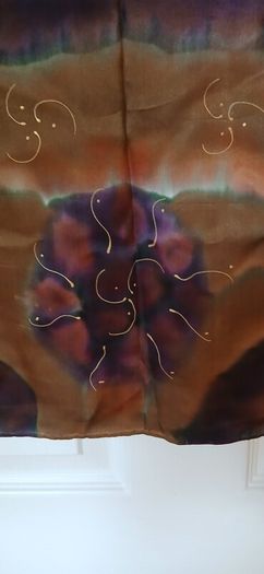 Hand painted, 100% silk scarf featuring a hand-rolled hem and custom metallic gutta detailing.