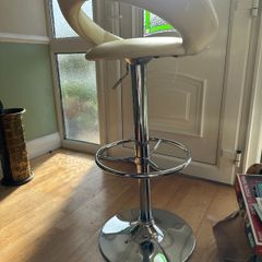 Luca Bar Stool or the Plump High/Low Gas Lift Bar Stool, featuring a faux leather curved seat and a chrome base