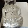 A glass Buddha figurine seated in the lotus position. Image 4