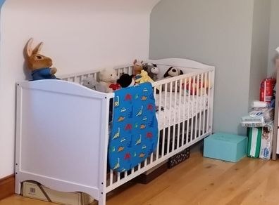 white cot and toddler bed and mattress